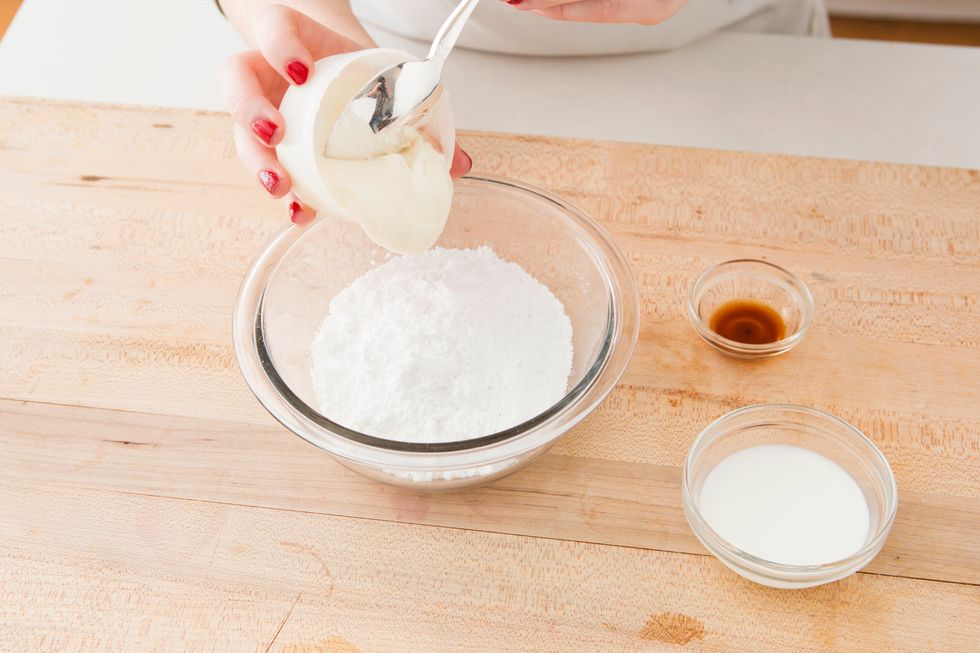 For your cream cheese glaze, mix together cinnamon roll icing and powdered sugar in a bowl. 