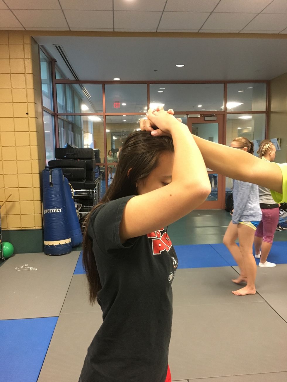 Forcefully push down the attacker's hand and knuckles with your hands