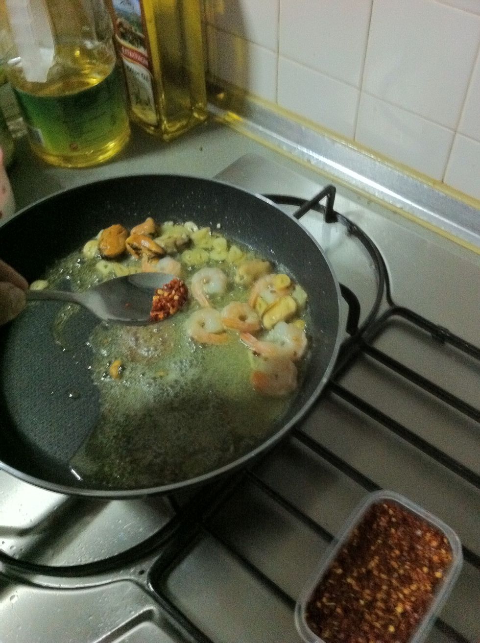 Forgot the chili flakes, you can also put this together with the garlic at the start in order for the oil to absorb it's flavors... without the seafood it's called aglio olio e peperoncino...\ud83d\ude0b