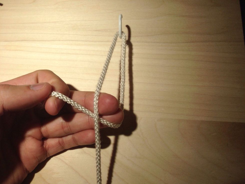Form a loop around your ring and middle fingers. Note the suture is now crossed at your fingers and not by the hook.
