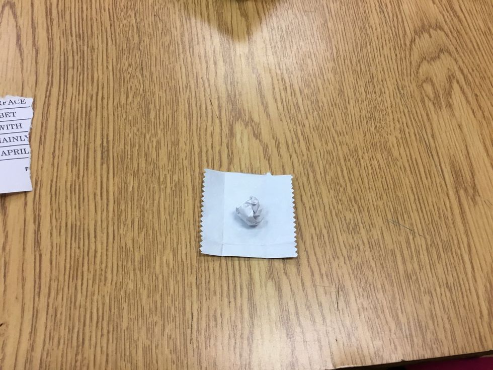 Form a piece of palate into a ball and put it in the middle of the gum wrapper