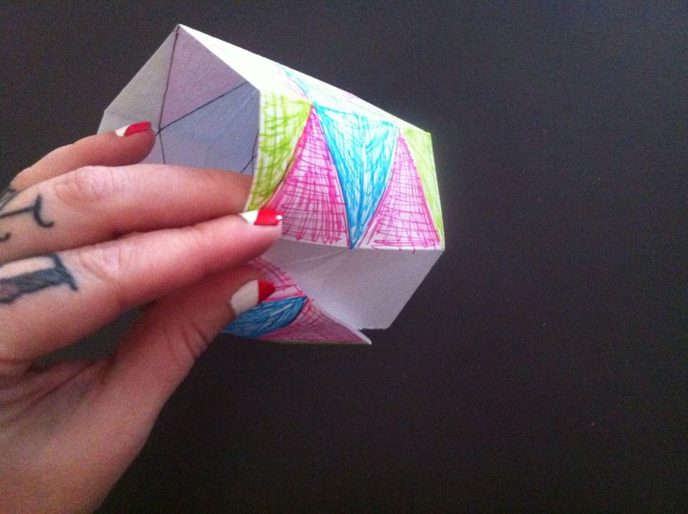 Form a ring & tuck the edge you didn't color into the flaps of opposite edge like this.