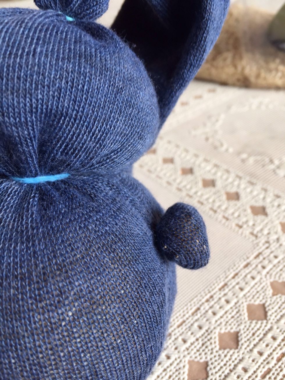 Form a tiny ball in back of bunny, tie off, and that is the tail.