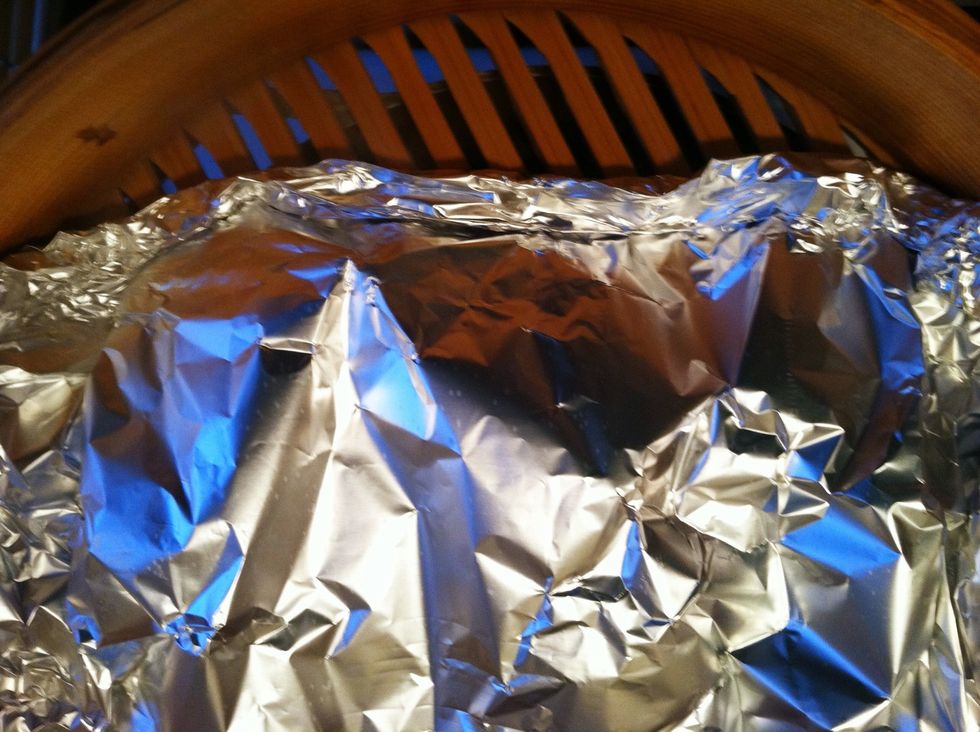 Form an envelope with the foil and double fold the ends. The wings will be steamed first and the liquid should stay inside the foil packet to cook them.