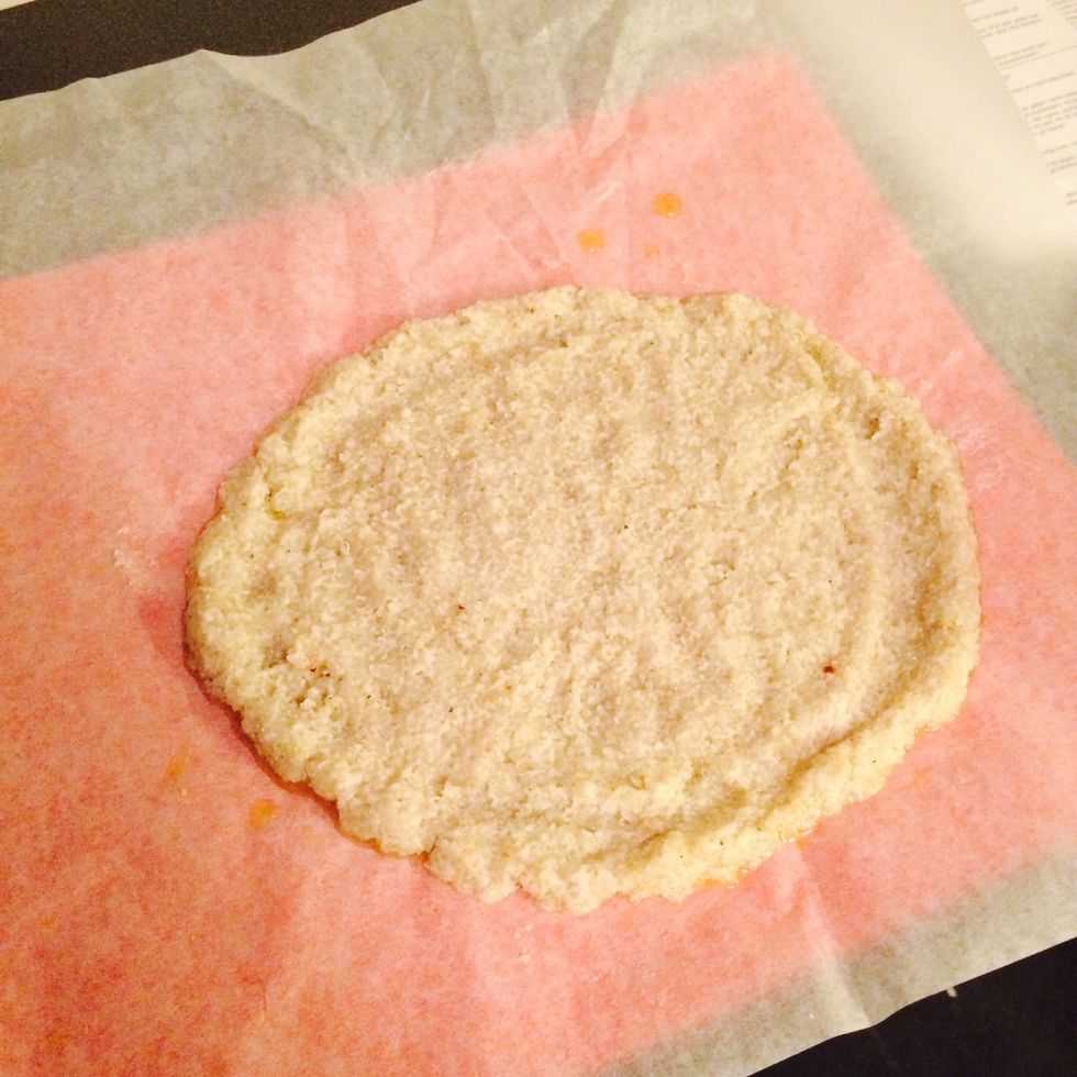 Form dough into a round pizza on parcement paper with a little olive oil.