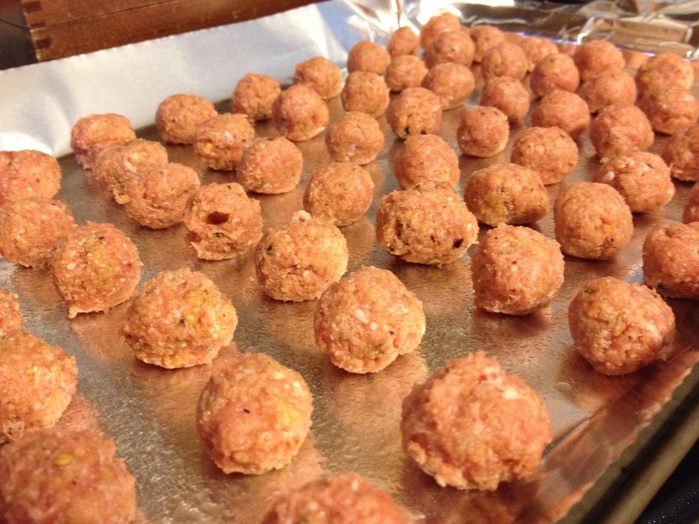 Form meat into very small meatballs. Put on cookie sheet lined with aluminum foil (greased). Bake in 350 degree oven for 15 minutes.