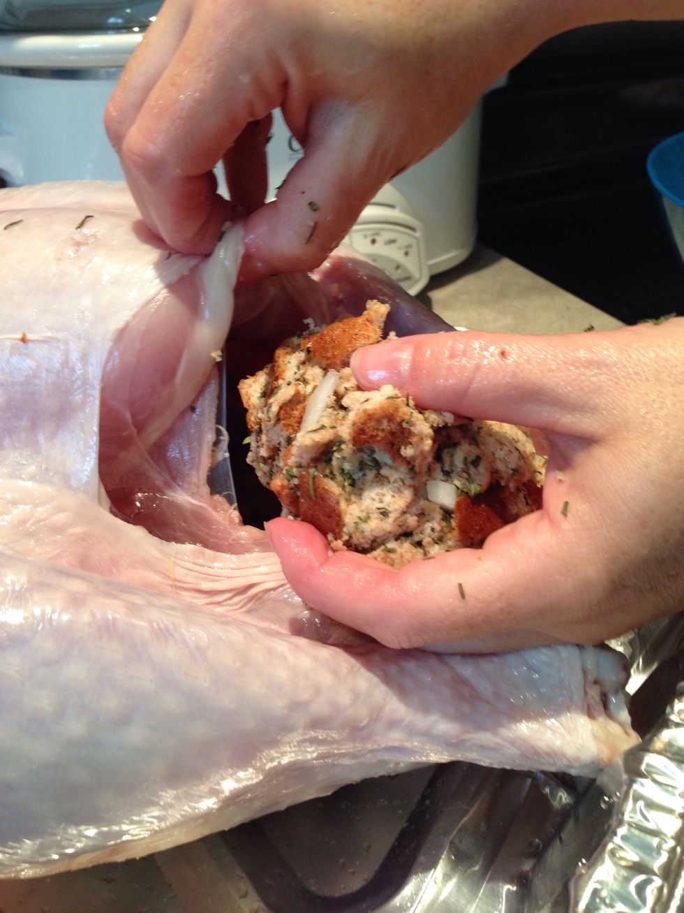 Form small balls of stuffing and push it into the large cavity of the turkey.