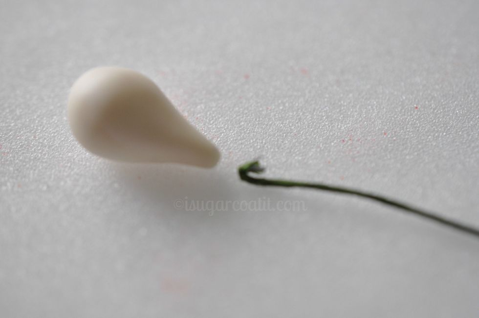 Form the ball into a bulb shape by using your opposite finger and palm to taper one end of the ball. This will become your bud.