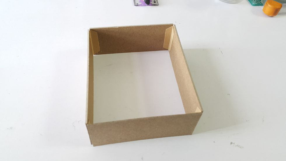 Form the box shape with tape or connection strips