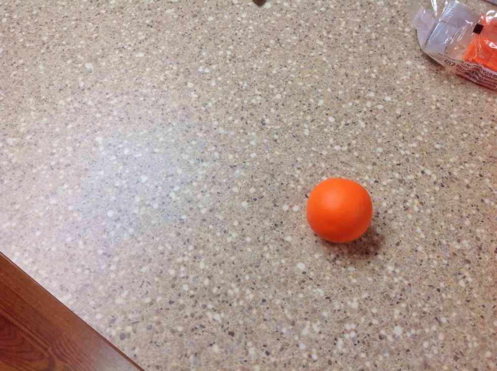 Form the clay into a ball. Place the ball on the hard surface.