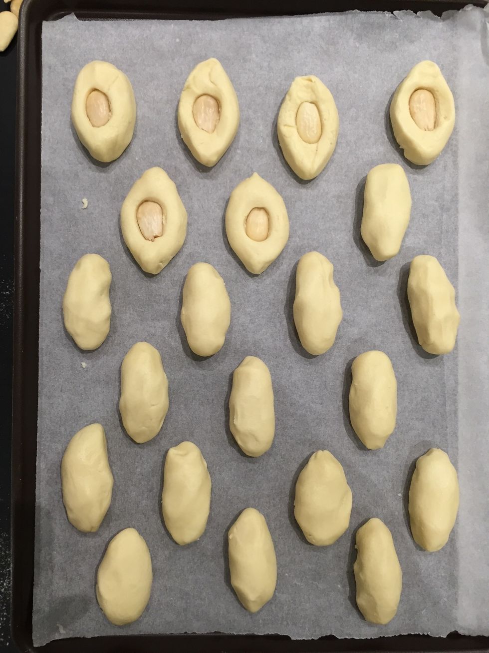 Form the cookies between the 2 hands. Put 1 whole almond and press it down. This recipe makes around 25 cookies..all depends on the size
