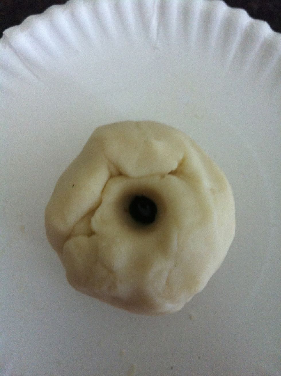 Form the dough into a clump and poke a hole in the middle. Put 5-8 drops of food coloring into the middle, if you'd like. Knead it again.