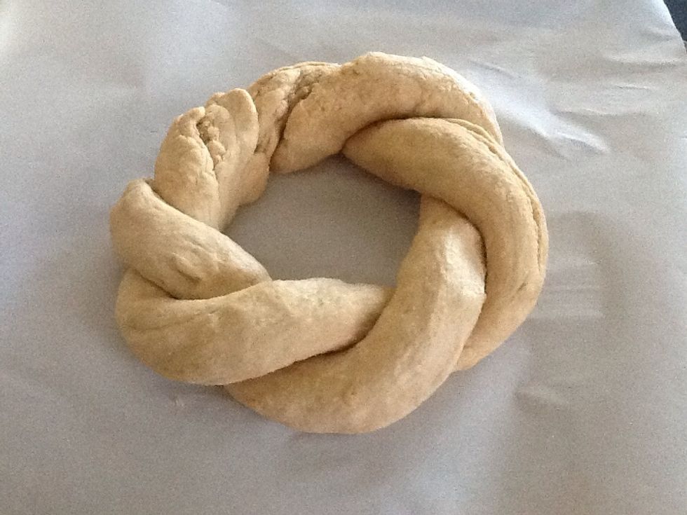 Form twist into a ring. Place on parchment paper on a baking sheet.