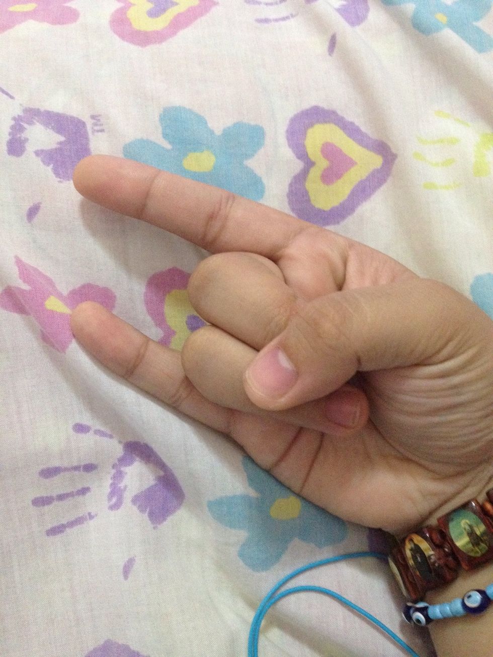 Form your hand into like this. The pinky and the pointer fingers are not folded. Just like when you do the "Rock 'N' Roll" hand sign. \ud83d\ude1c