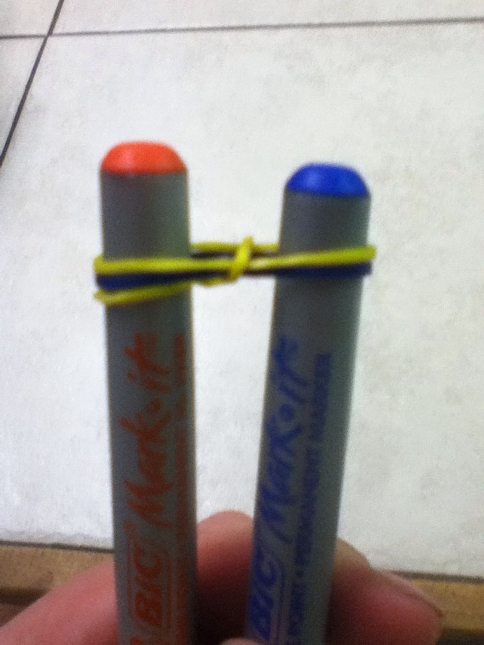 Fourth, So that the bottom ruberband is in the middle of the sharpies