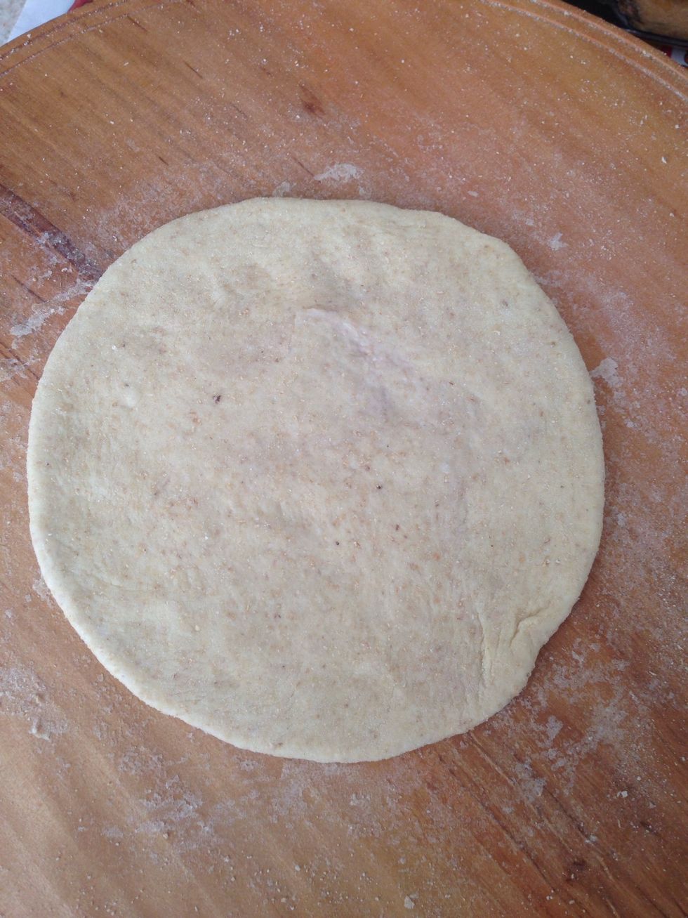From a fresh dough, make a chapati half the size of an actual one.