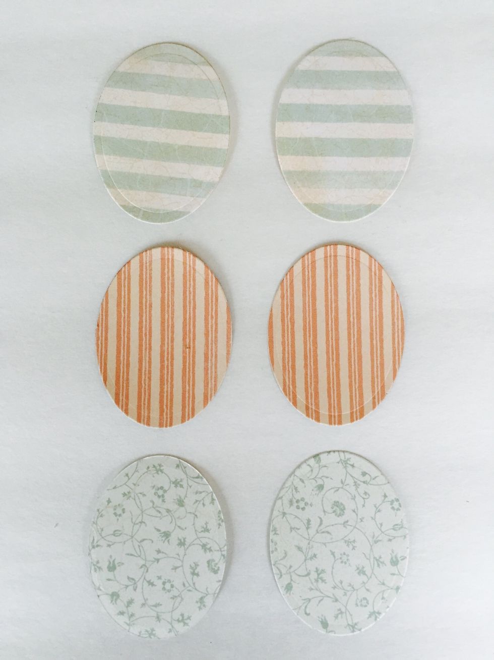 From Baby 2 Bride, remove paper with light blue stripes and paper with white background and blue vines. Pink stripe paper is from Springtime pad. Use 2" oval die and cut (2) ovals per design. Ink.