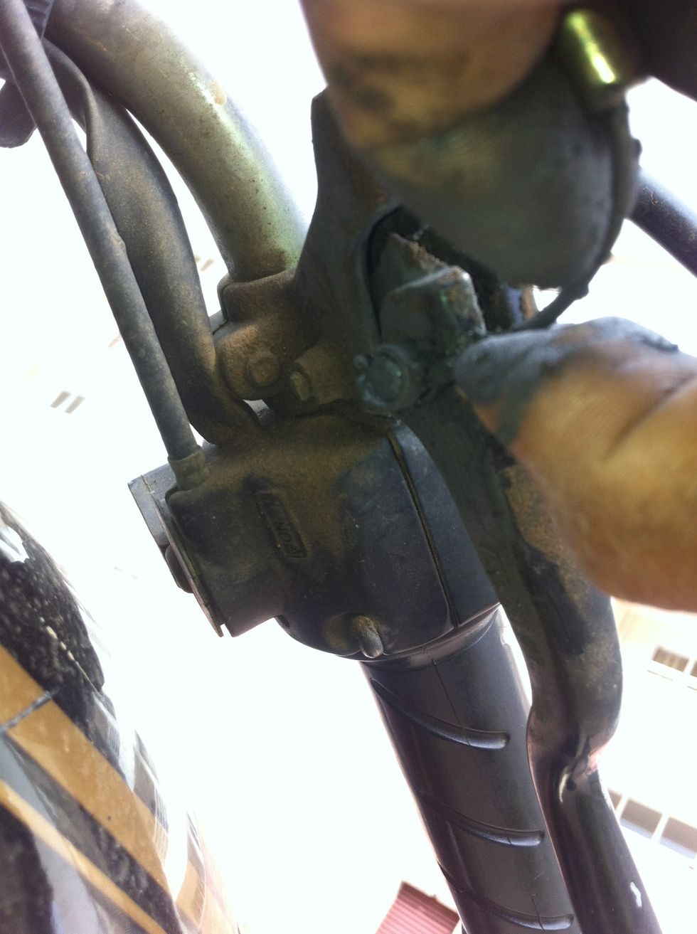 From below the lever you should be now able to pull the cable end out