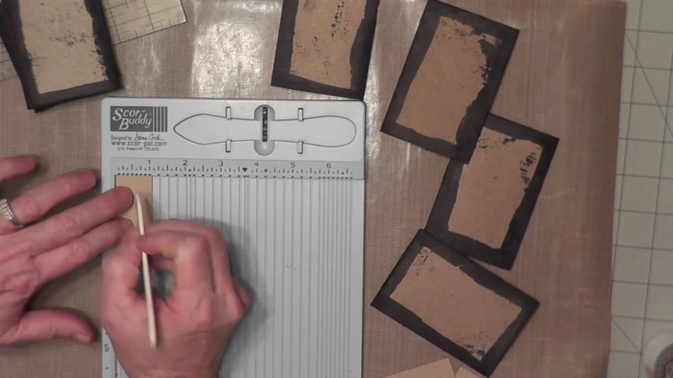 From cardstock, cut four pieces 2 1/2" long x 1" wide. Score the 1" side at 1/2" to create 4 hinges for your album pages.