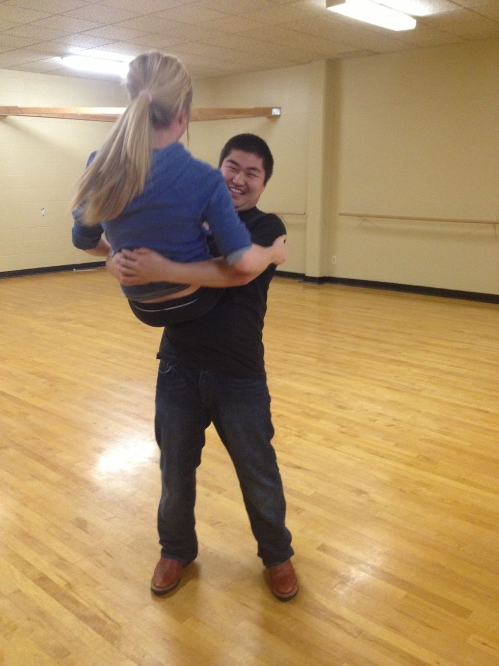 From here, her right leg will drop off the your shoulder. Before her leg drops you can dip her down. But she should fall back in the cradle but facing the other direction.