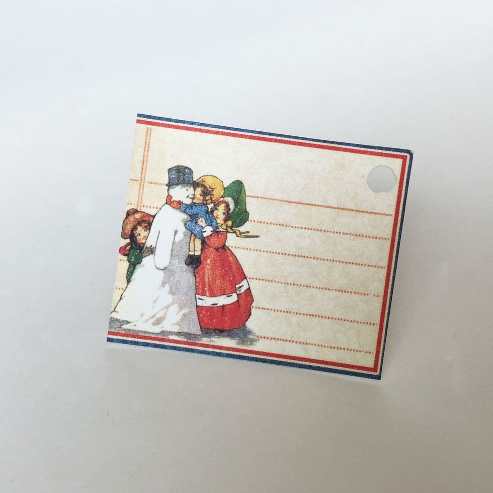 From January Collective (front) cut out the snowman cutout on far left of the sheet and punch a hole on the top right corner.