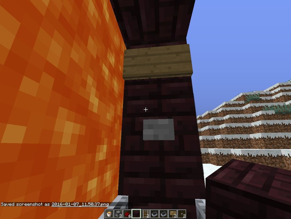 from outside, right click through the lava and ride in minecart to get behind the lava