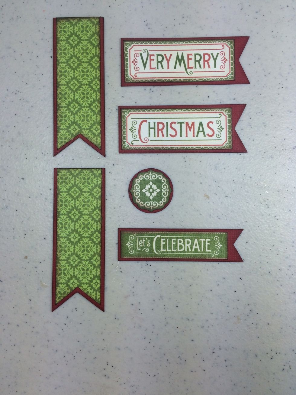 From red cardstock, cut two 1 1/8" x 3 1/8", 2 more pieces 1 1/8" x 2 7/8". Cut a 1" circle. And one 3/4" x 2 3/4". Adhere cut-aparts to cardstock as shown.