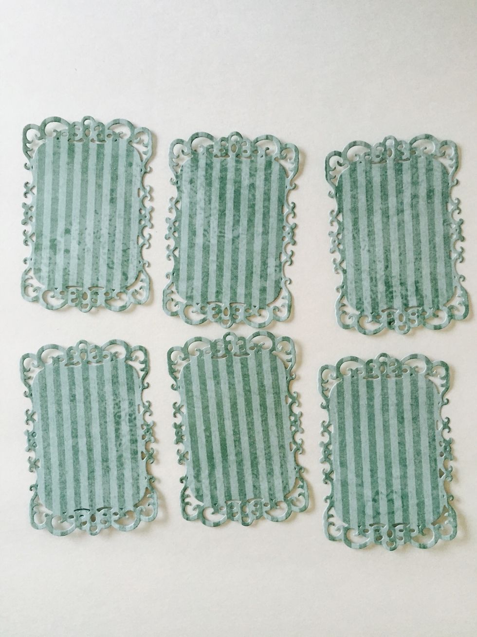 From Springtime paper, remove a blue striped piece (blue butterflies on reverse). Cut (6) shapes using the second smallest Decorative Labels Eight die. Lightly ink edges.