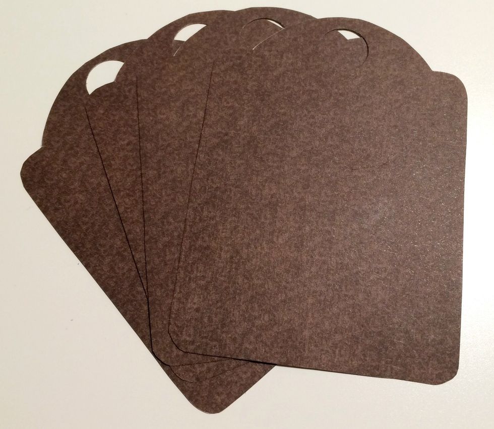 From the 6x6 pad, pull out 2 brown dot papers. Trace Thanks tag 4 times on the brown dot paper. Cut each tag out. With a 1/2" circle punch, punch a hole at the top of each tag so the eyelet can fit.