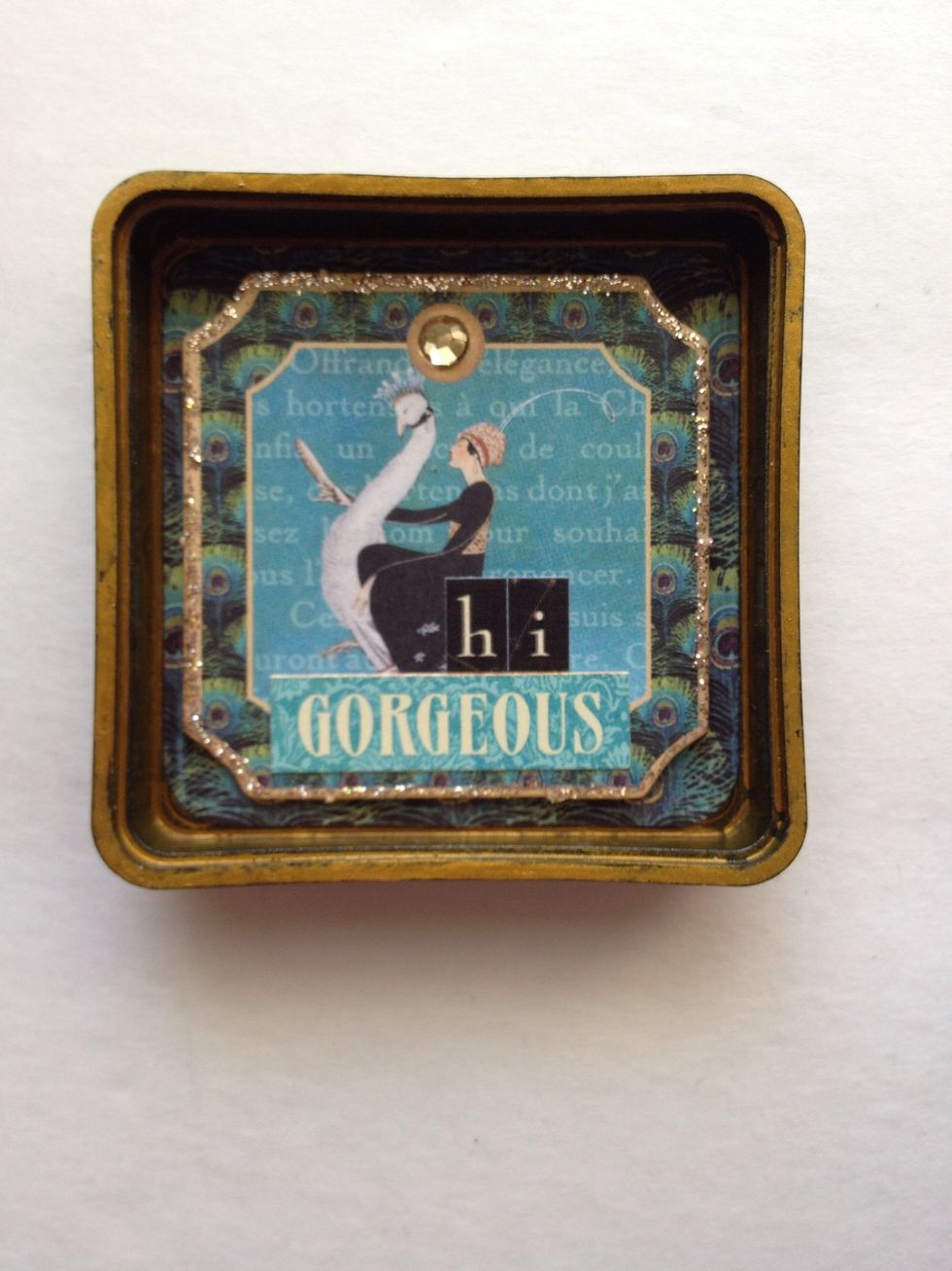 From the alphabet sticker sheet, adhere the letters "h" and "i" along with the word "gorgeous".