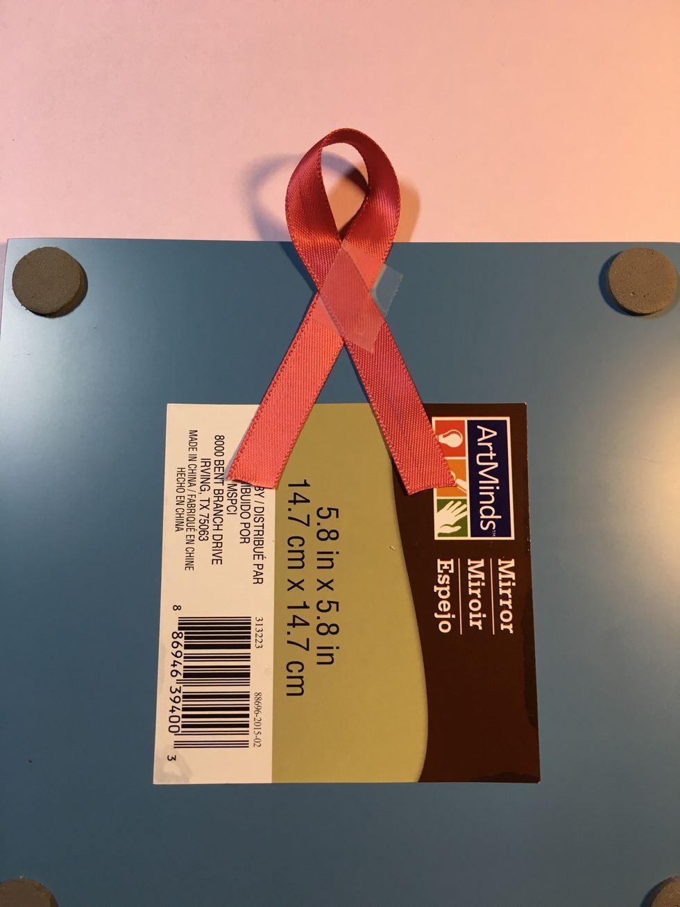 From the back, position the ribbon with a small loop at the top. Tape and check placement. When placed as desired, secure with strong tape, hot glue, or other adhesive.