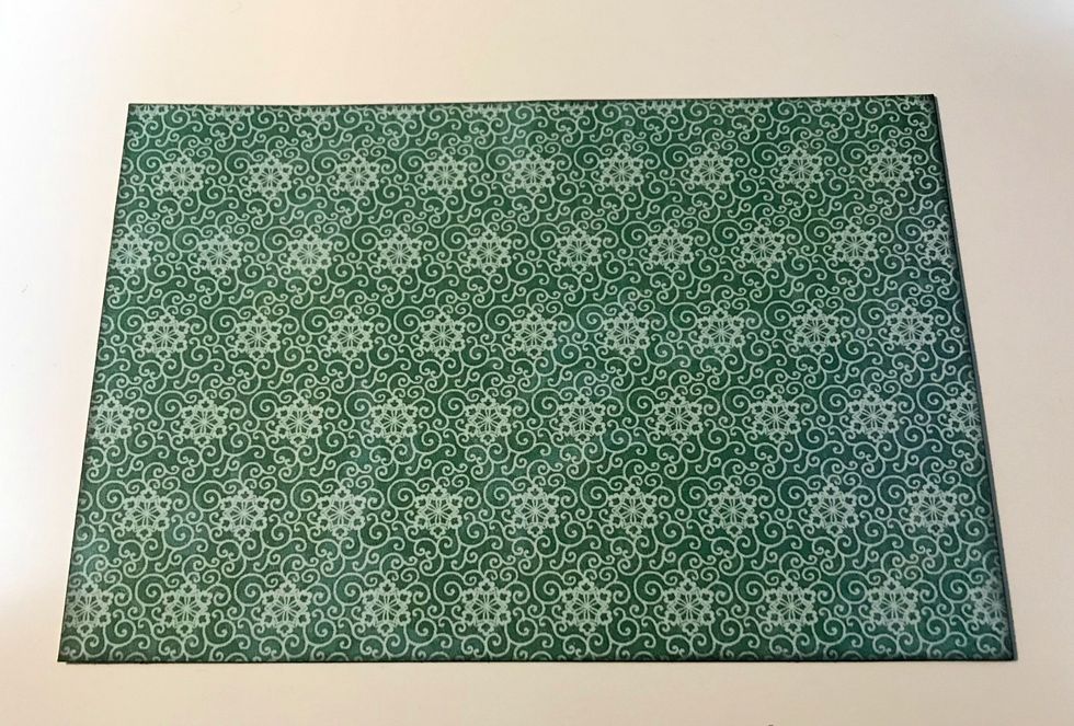 From the backside of the Fairie Dust paper, cut a piece that measures 4 1/4" x 6 1/4". Ink the edges of the paper using Photogenic Ink and a blending tool.