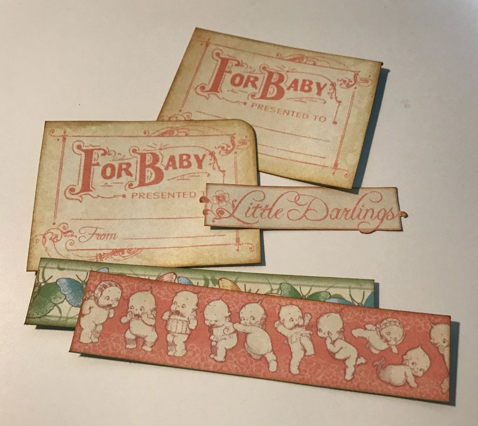 From the border paper, cut out two for baby, little darlings & two borders. Cut one border to 4 1/2" & cut the other to 4 1/4". Ink edges of pieces using Vintage Photo Distress Ink & a Blending Tool.