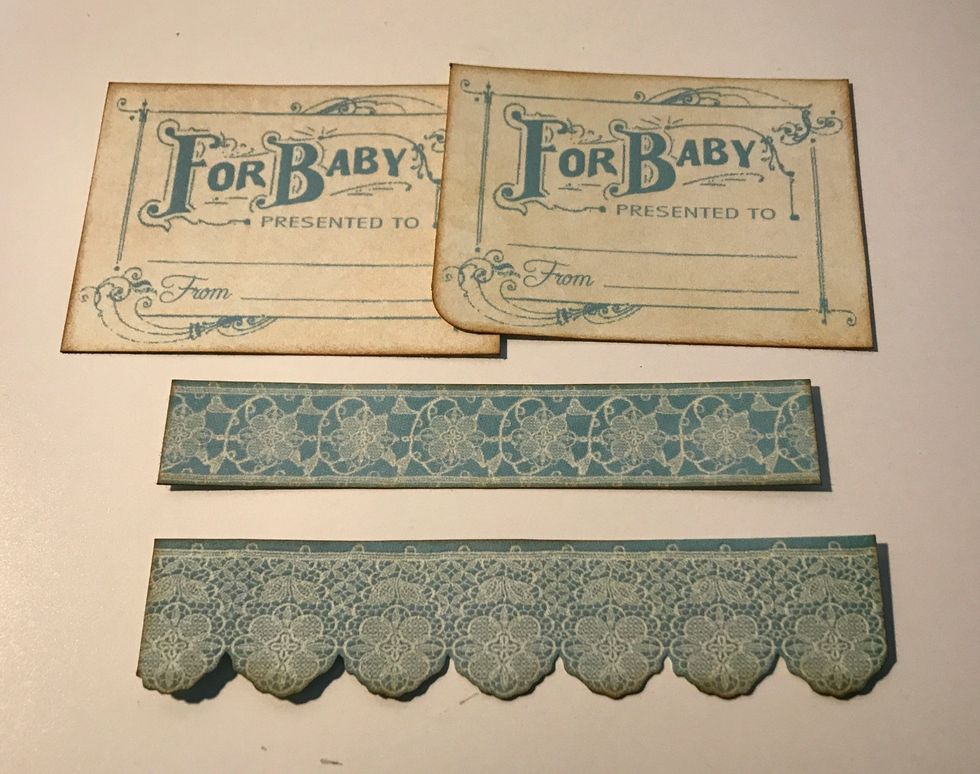 From the border paper, cut out two for baby & two borders. Cut one border to 4 1/2" & cut the other to 4 1/4". Ink edges of pieces using Vintage Photo Distress Ink & a Blending Tool.