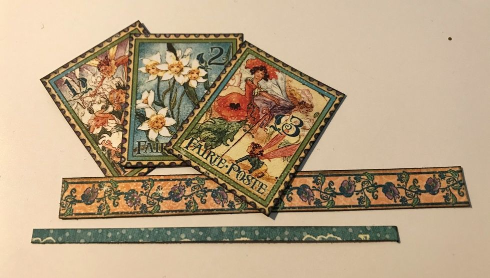 From the borders paper, cut out 3 stamps out, the floral border and the small blue border. Cut the floral border to 4 1/2". Cut the blue border to 4". Ink the edges using the Photogenic Ink.