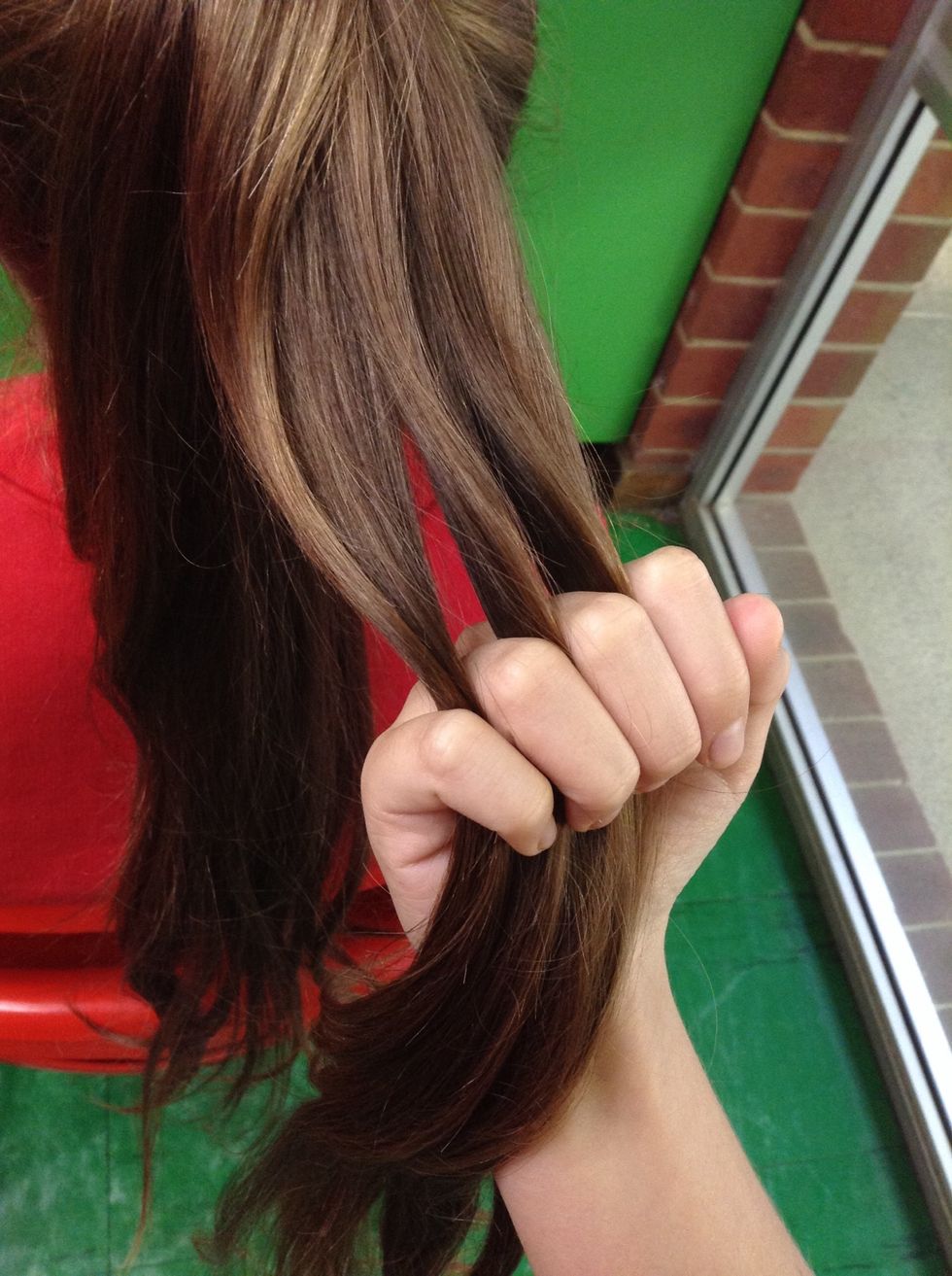 From the bunch of hair separate it into three equal parts.