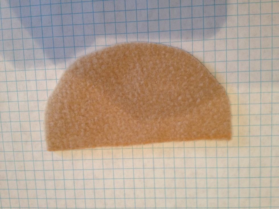 From the fleece, cut out a half moon shape. The size really depends on how big you want your hedgehog's head I be, but mine is 4 1/2 in. (Top) x 2 1/2 (deep) if you have questions just comment.