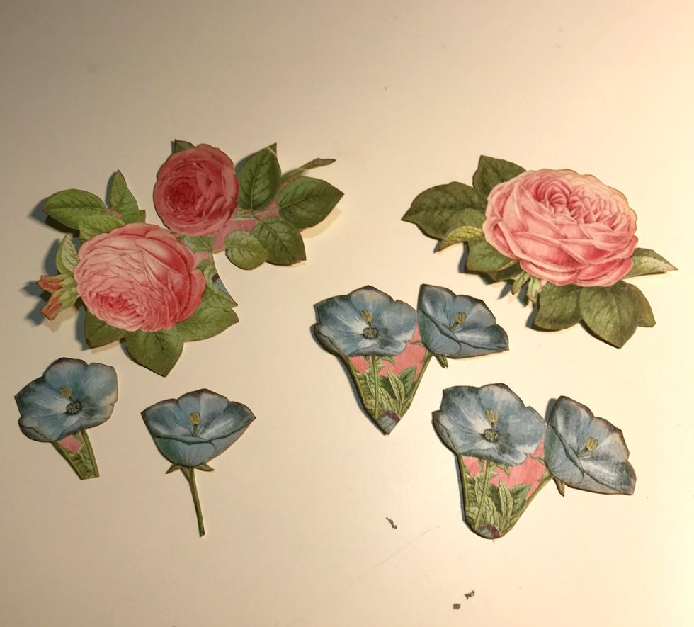 From the floral paper, fussy cut a single rose, a rose bunch and six blue flowers. Ink the edges of the flowers using Vintage Photo Distress Ink.