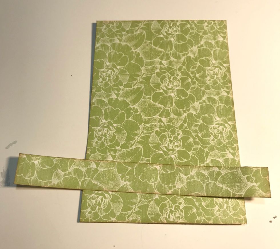 From the green/white floral paper, cut a piece that measures 4 1/4" x 6 1/4". Cut a second piece that measures 3/4" x 6 1/4". Ink the edges of the paper using Vintage Photo Distress Ink.