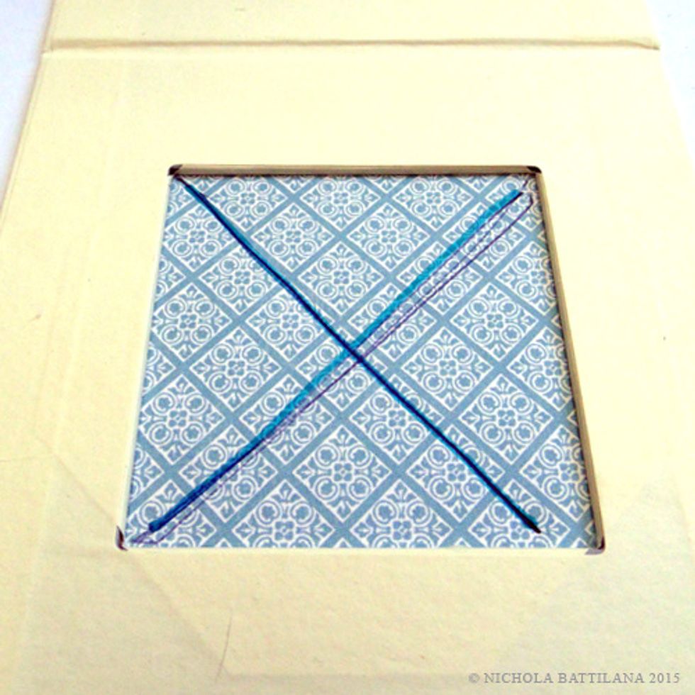 From the inside of the box, draw an X in the window and cut along the lines.