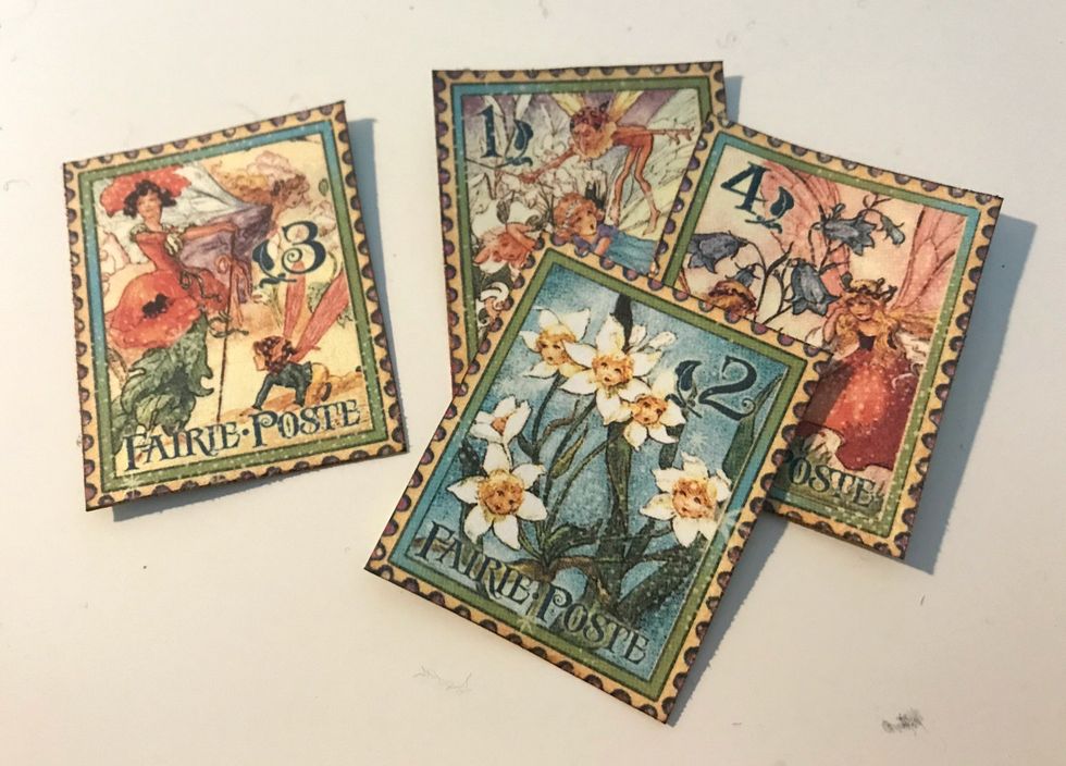 From the Magic Wishes paper, cut out 4 stamps. Ink the edges of the stamps using Vintage Photo Distress Ink.
