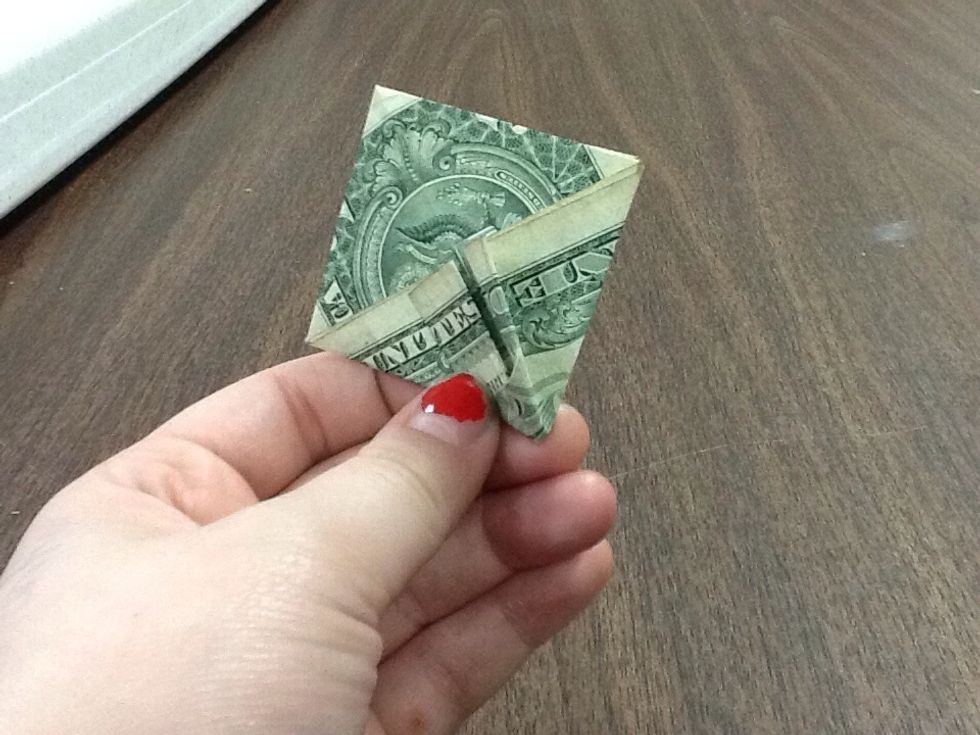 From the outside of the pocket, gently push it in, and take the other side of it and pull it back as you do so. Use the creases as a guide of where to fold.