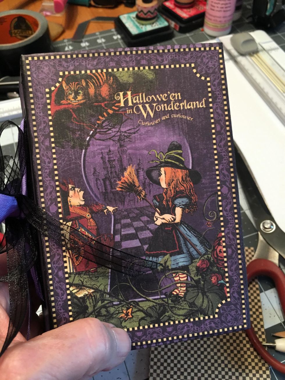 From the paper collection, cut out an image that you want for the front of the junk journal book.