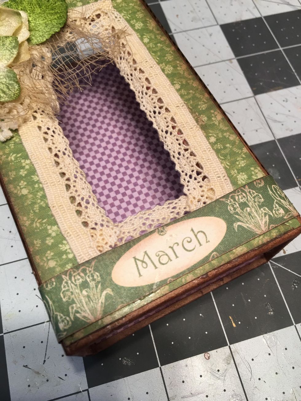 From the pattern paper, cut out a strip with the word "March" to fit on the bottom of the lid. Glue into place.