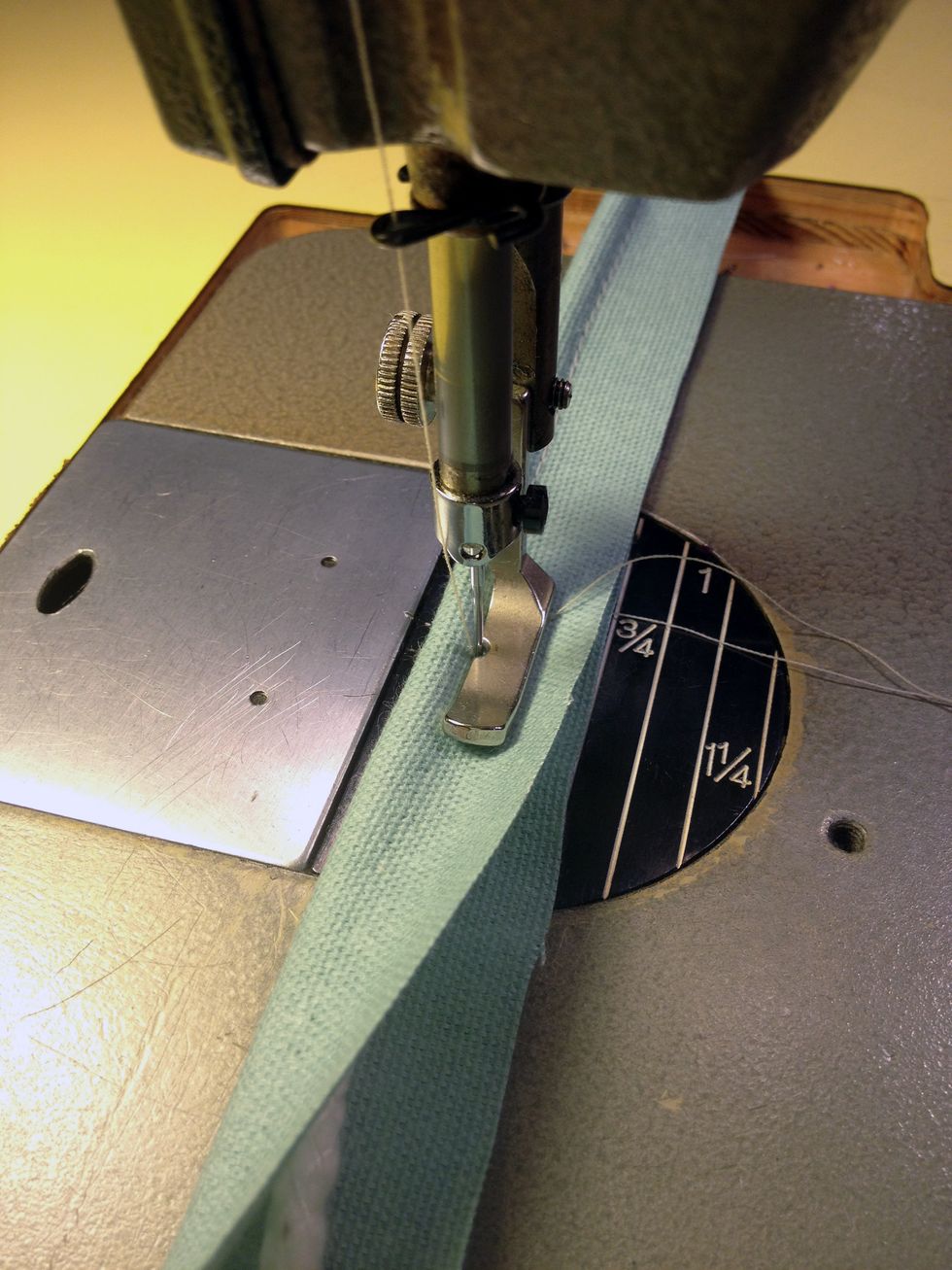 From the Piping Fabric - cut 2 strips of fabric 1-1/2" wide x 54" long and cover the piping with the fabric as shown. You will need to use a zipper foot on your machine.