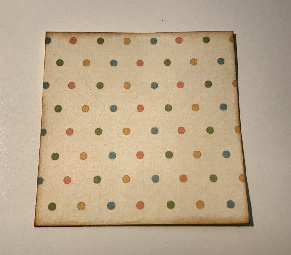 From the polka dot paper, cut a piece that measures 2 3/4" x 2 3/4". Ink the edges of the paper using Vintage Photo Distress Ink and a blending tool with foam.