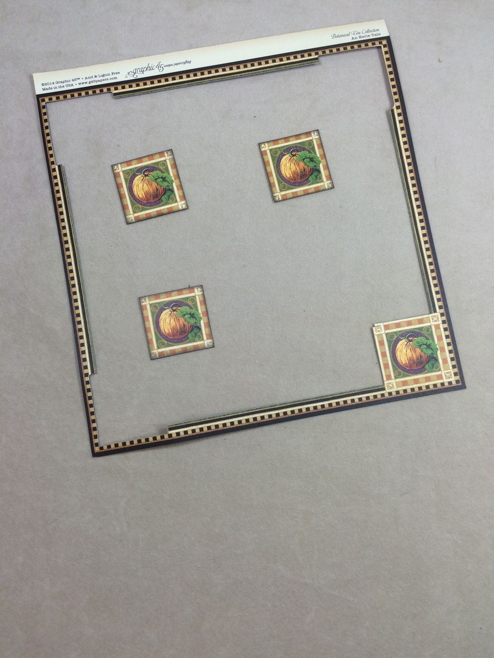 From the remaining frame of An Eerie Tale signature page, cut out 3 of the 4 pumpkin squares. (1 3/8" x 1 3/8")