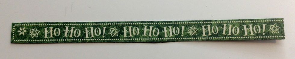 From the Season's Greeting paper, cut out the Ho Ho Ho border. Cut the border down to 4 7/8".
