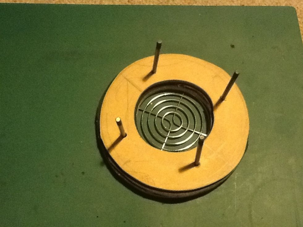 From the side of the guard push thru the four longbolts. These should be longer than the assembly of the whole fan unit to allow the fan to slide up and down to create a clamp.