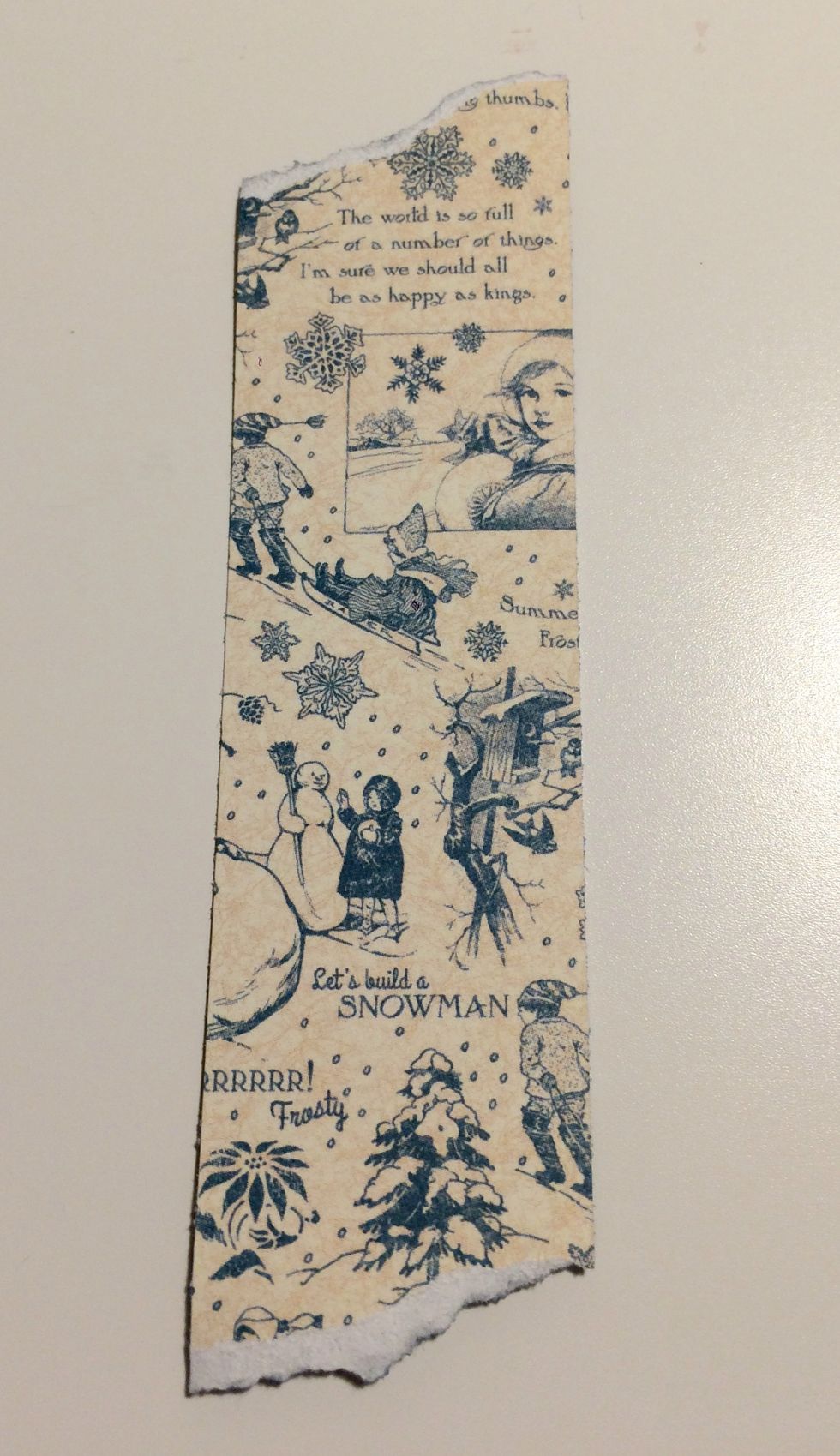 From the solids and patterns pad, use the rest of the winter patterned paper. Cut a piece that measures 1 1/4" x 4 7/8". Tear a bit off the top and bottom of this paper.